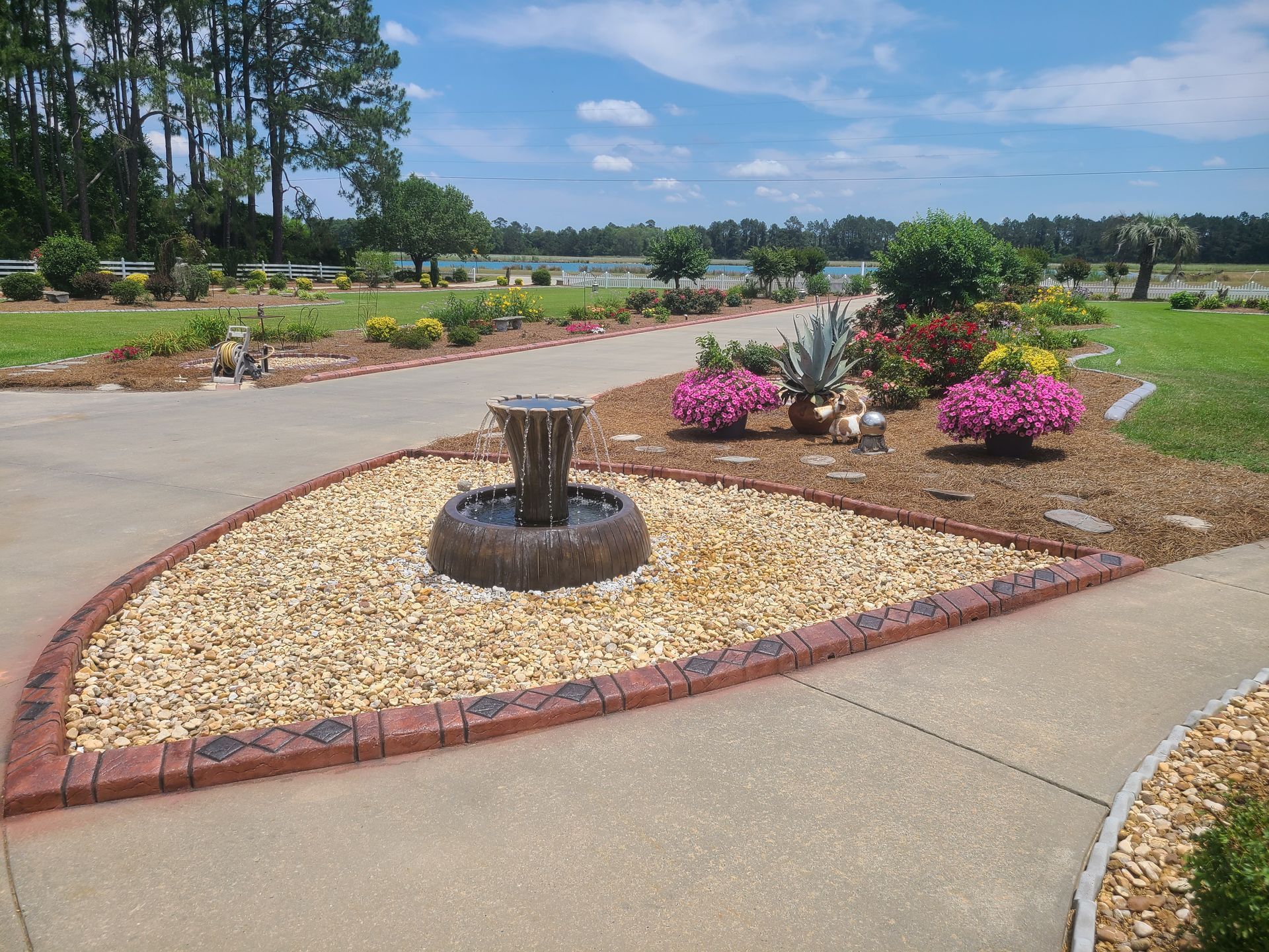 A garden with a fountain in the middle of it
