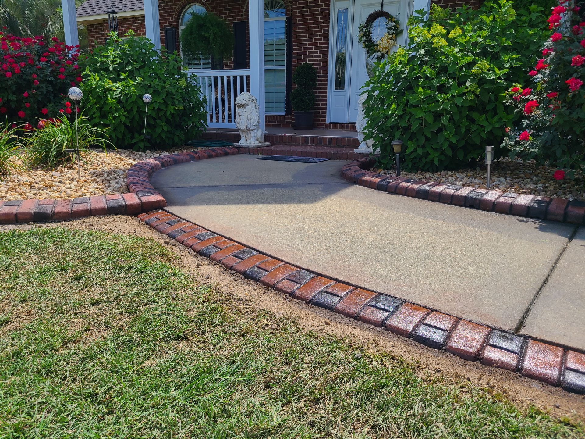A brick walkway leading to the front door of a house