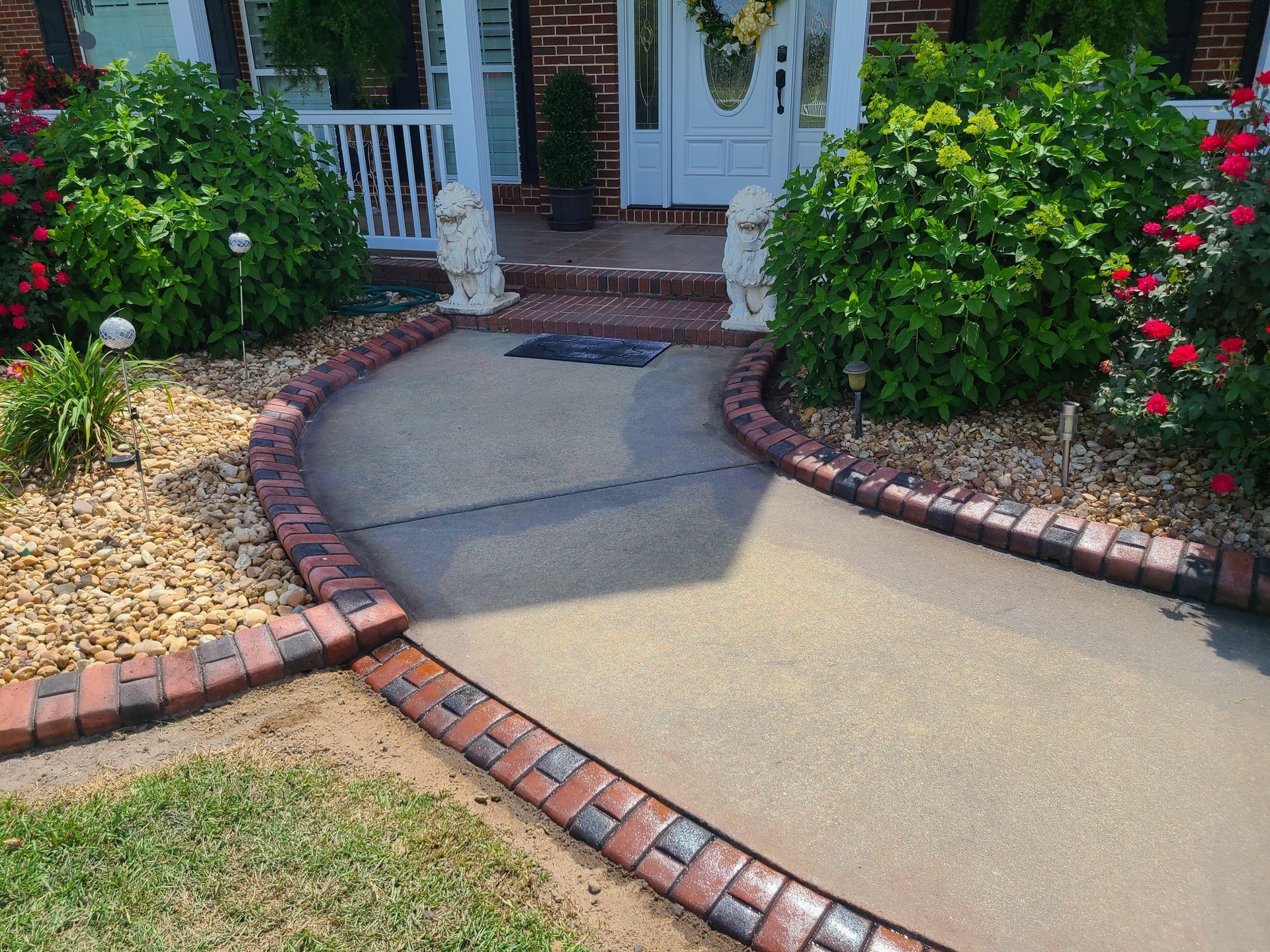 A brick walkway leading to the front door of a house