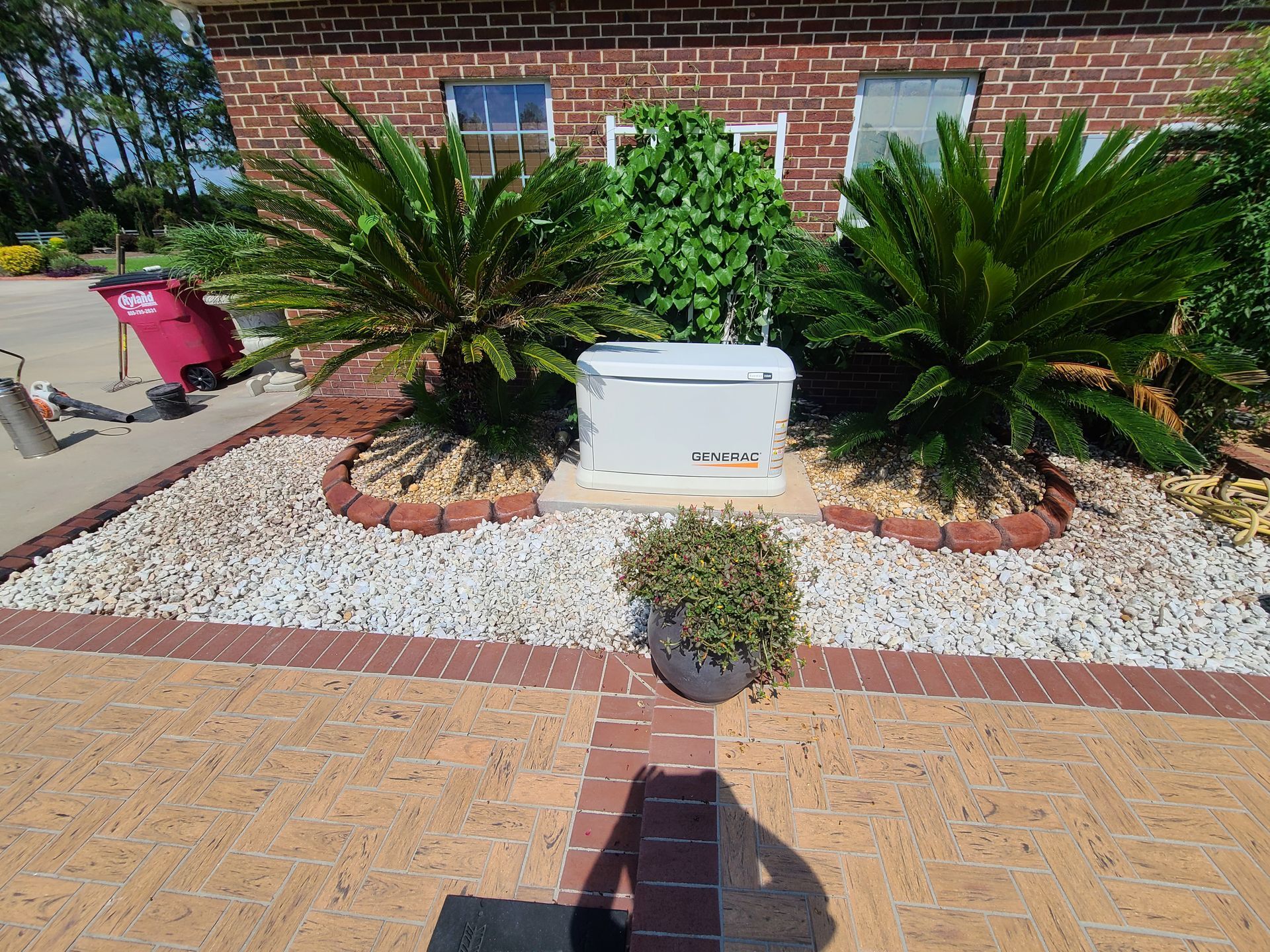 A brick house with a lot of plants in front of it