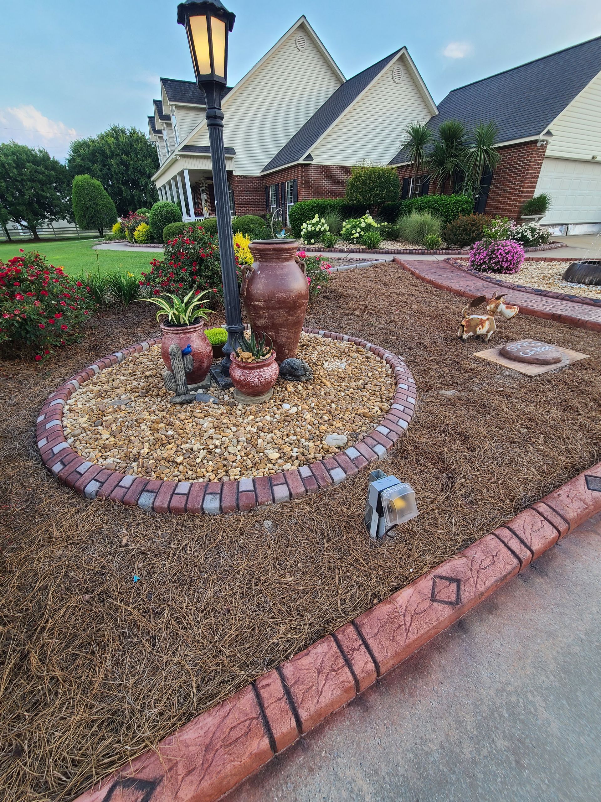 There is a lamp post in the middle of the garden.