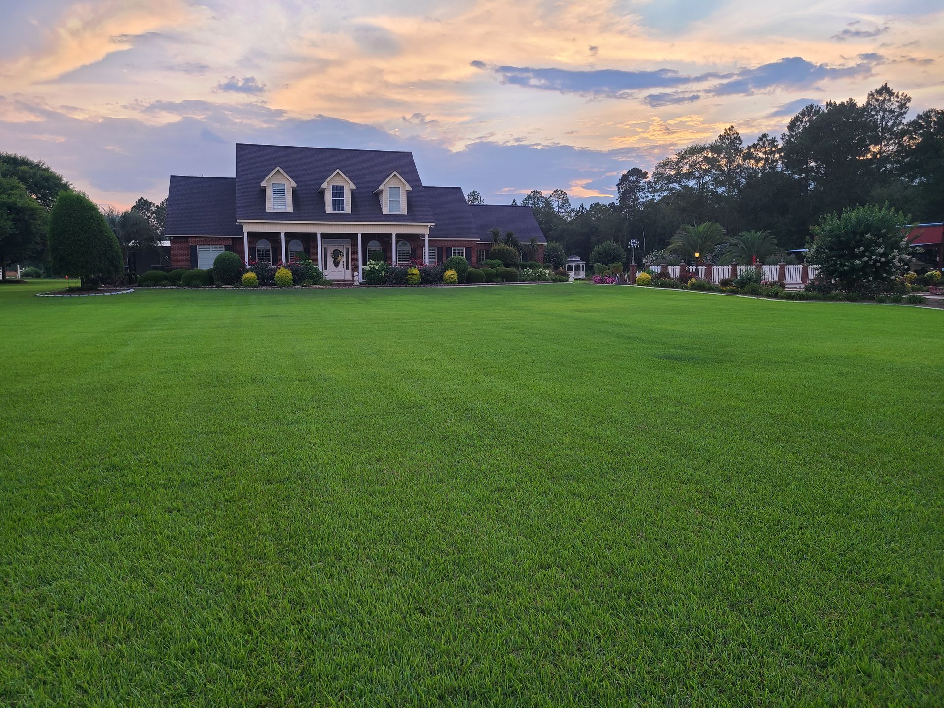 A large house with a large lawn in front of it.