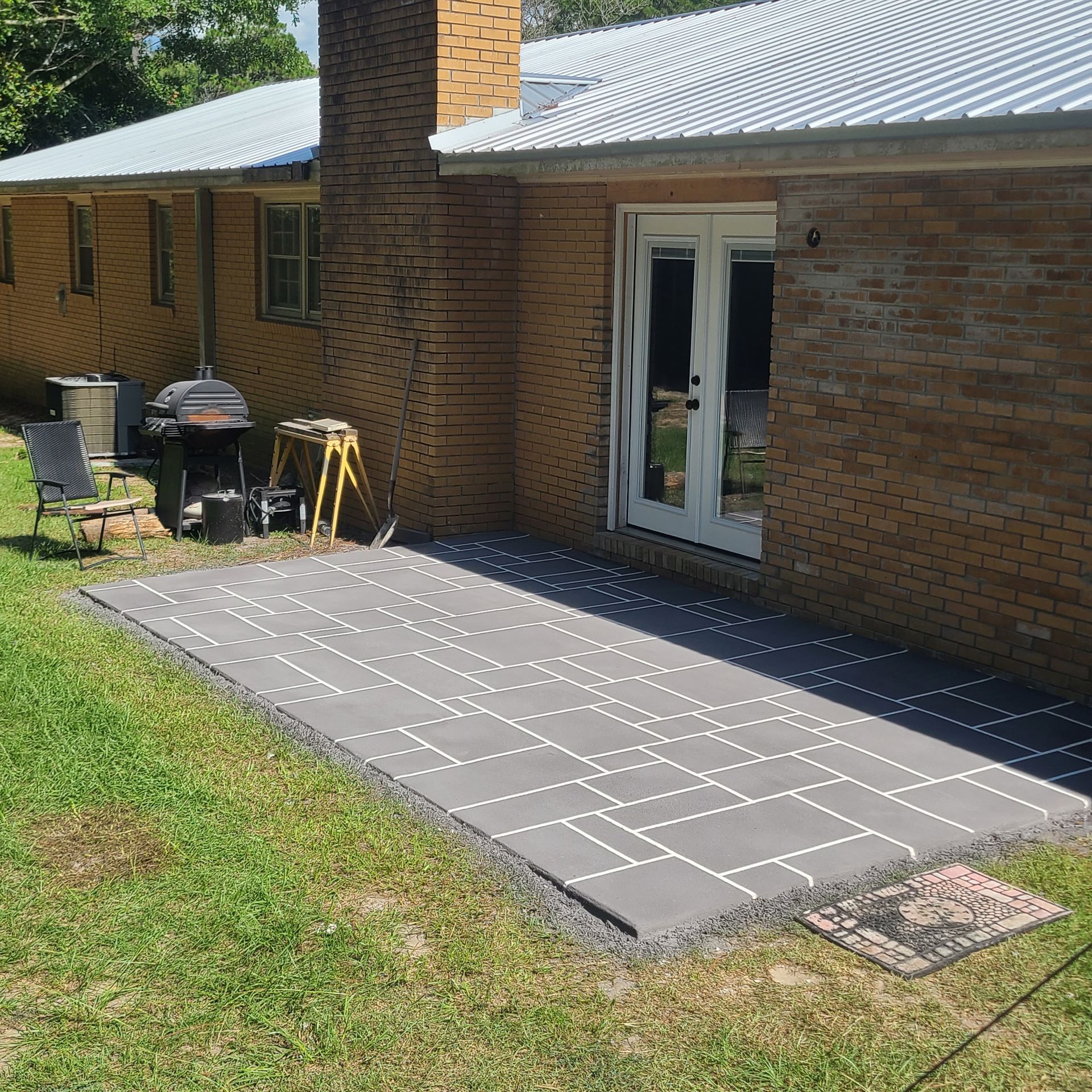 A brick house with a patio in front of it.