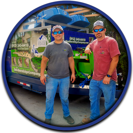 Two men standing in front of a truck that says edge