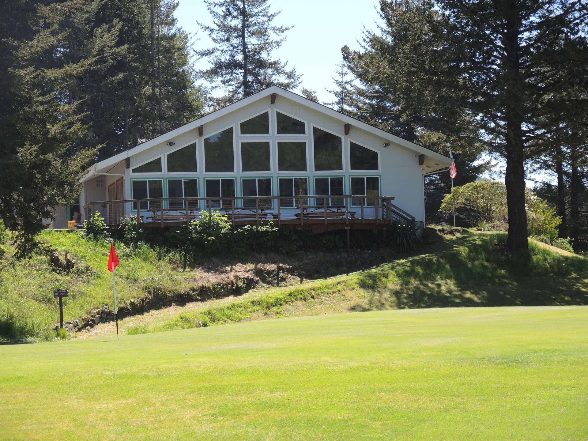 A Large White House Sits on Top of A Lush Green Hillside