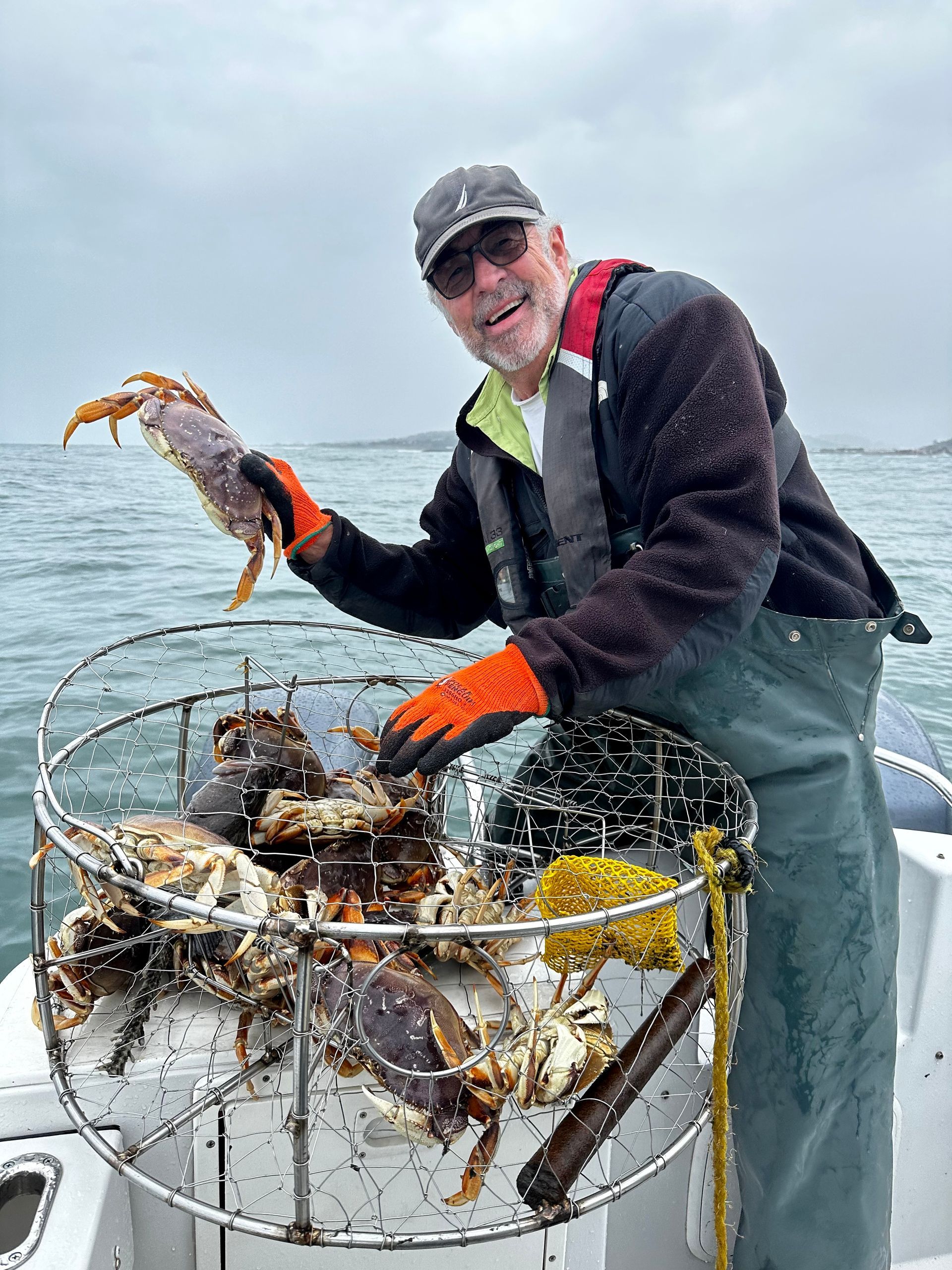 Man Is Holding a Crab in A Cage on A Boat