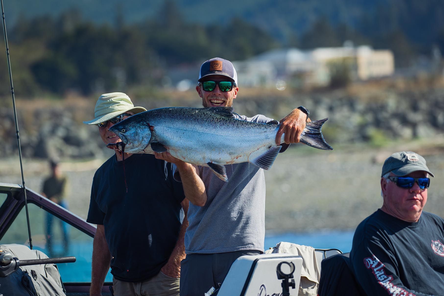 Man Holding a Large Fish on A Boat