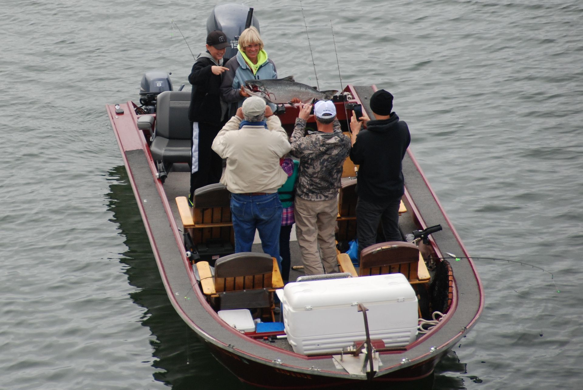 Group of People Fishing in A Boat on A River