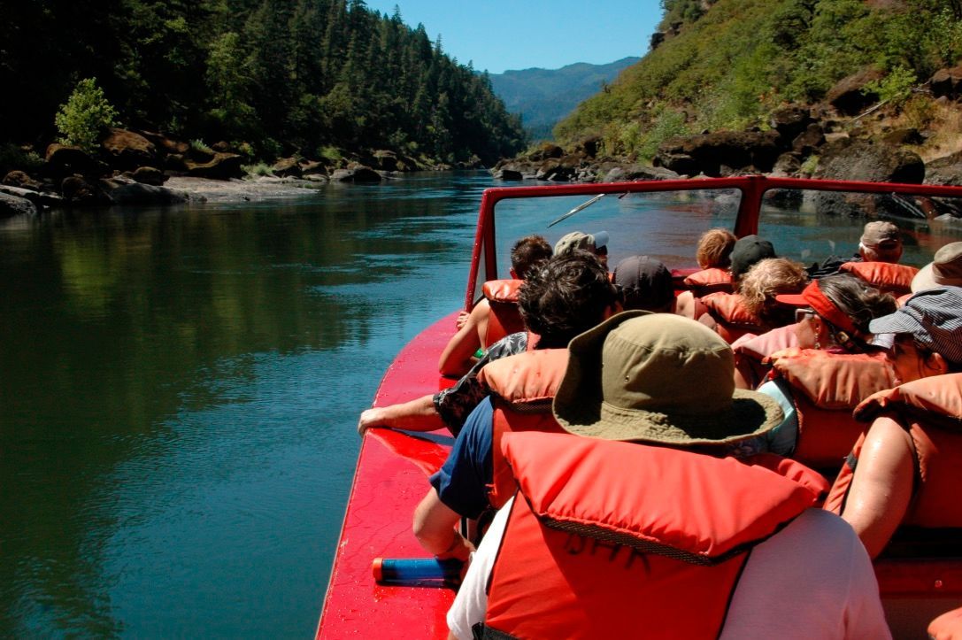 Group of People Are Riding a Boat on A River