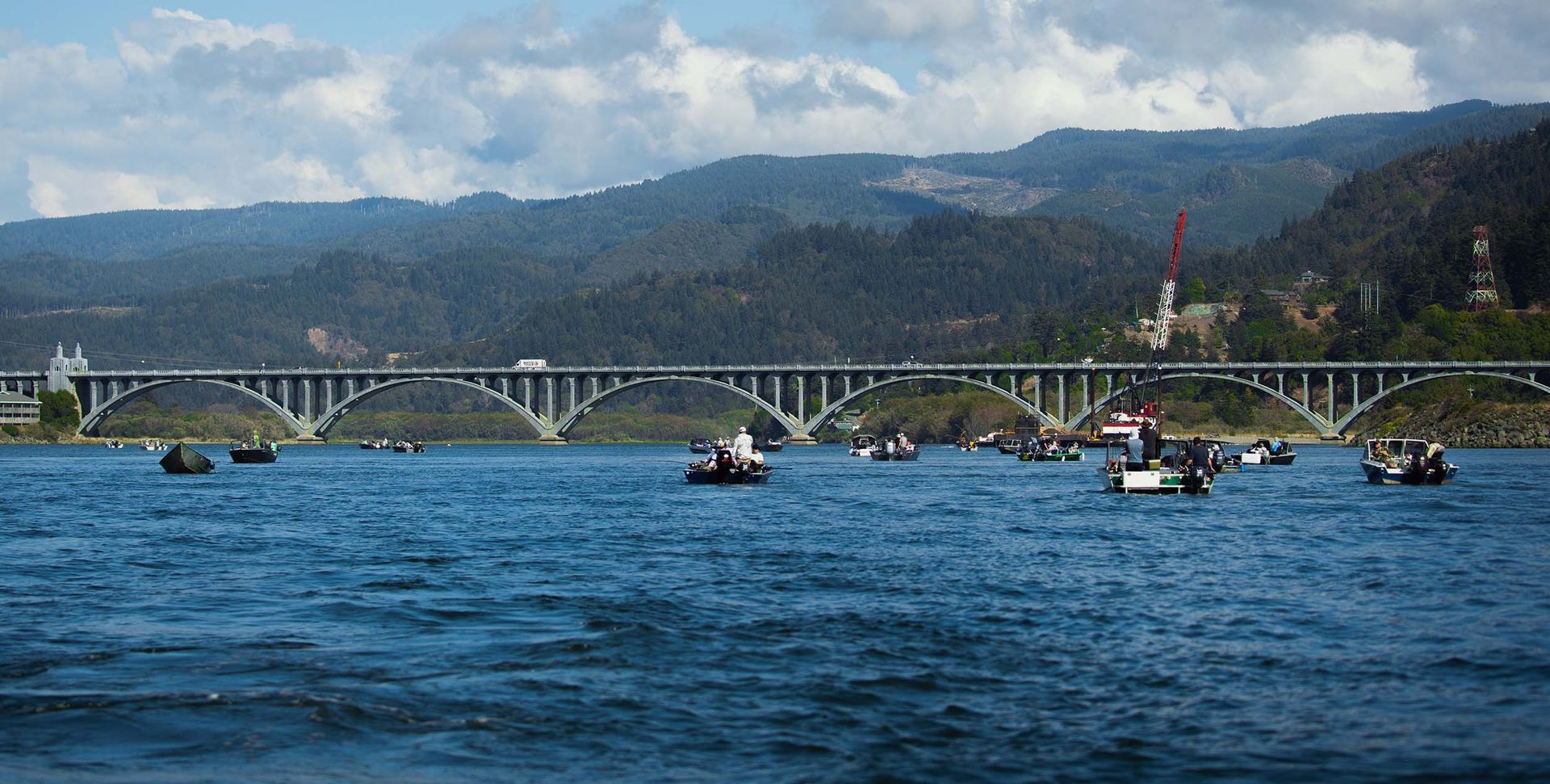 A Bridge Over a Body of Water with Boats in It