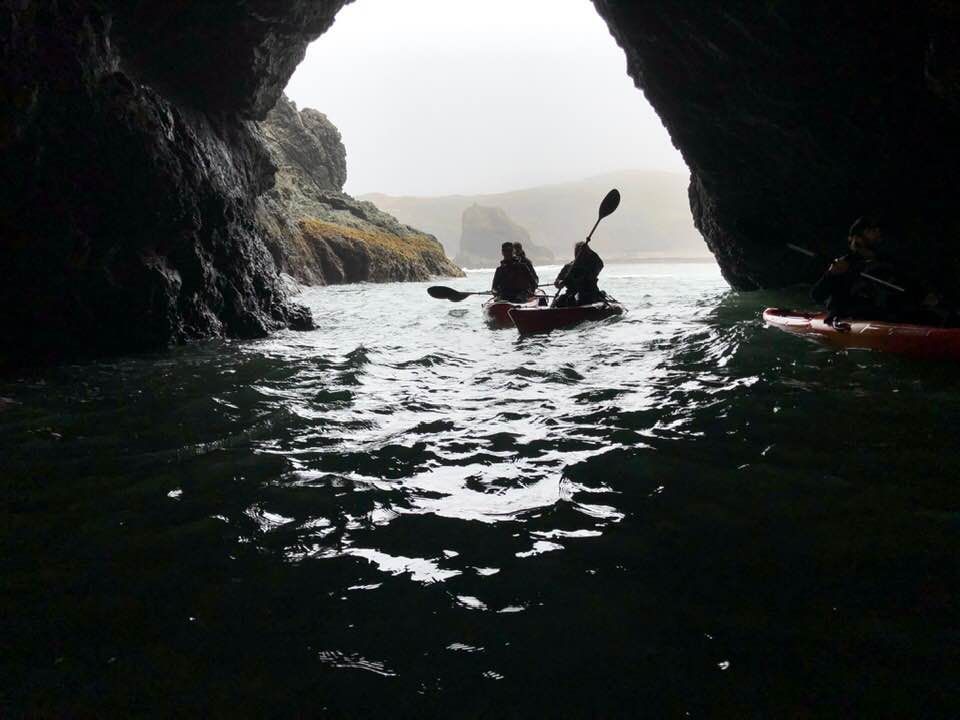 Two People in Kayaks in A Cave