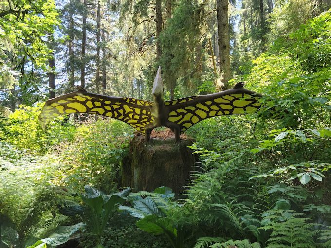 Statue of A Dinosaur in the Middle of A Forest