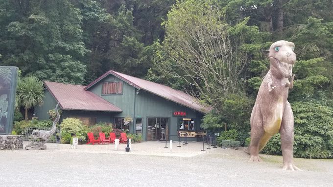 Statue of A Dinosaur in Front of A Building