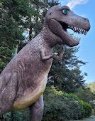 Statue of A T-Rex Dinosaur with Its Mouth Open in A Park