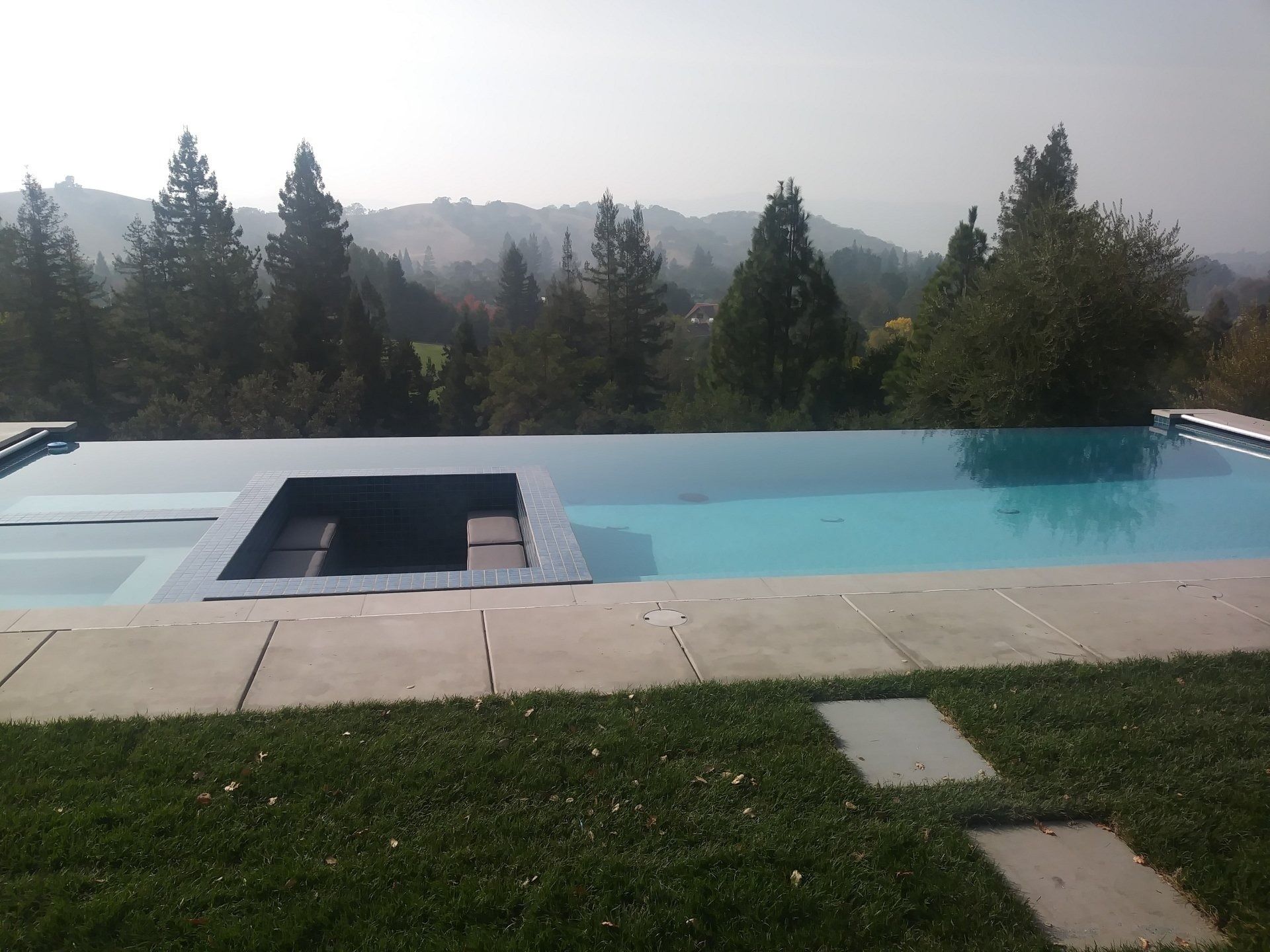 A large swimming pool with trees in the background