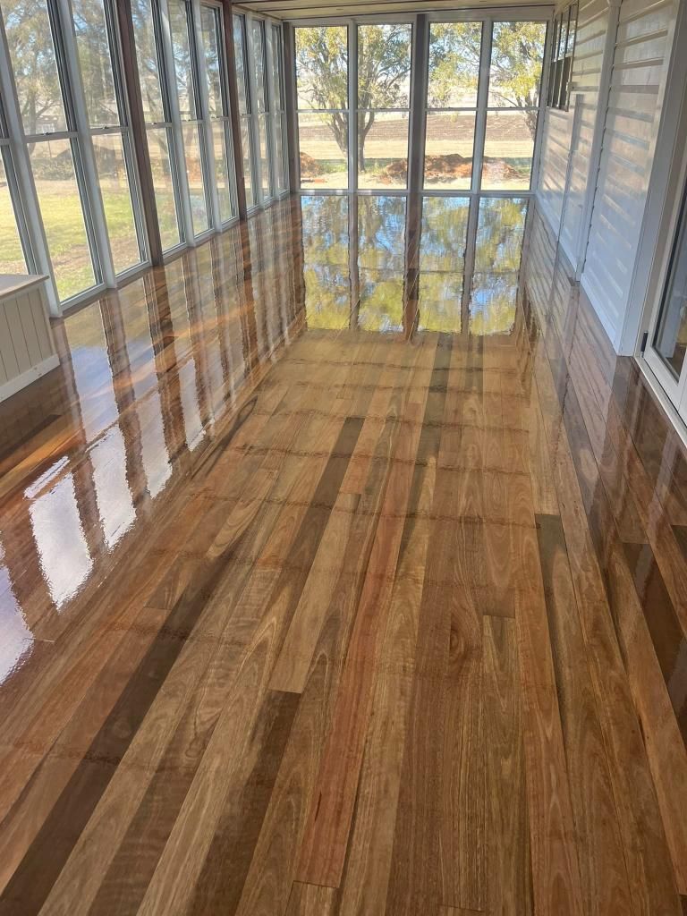 A Room With a Lot of Windows and a Wooden Floor — Toowoomba Polished Floors in Warwick, QLD
