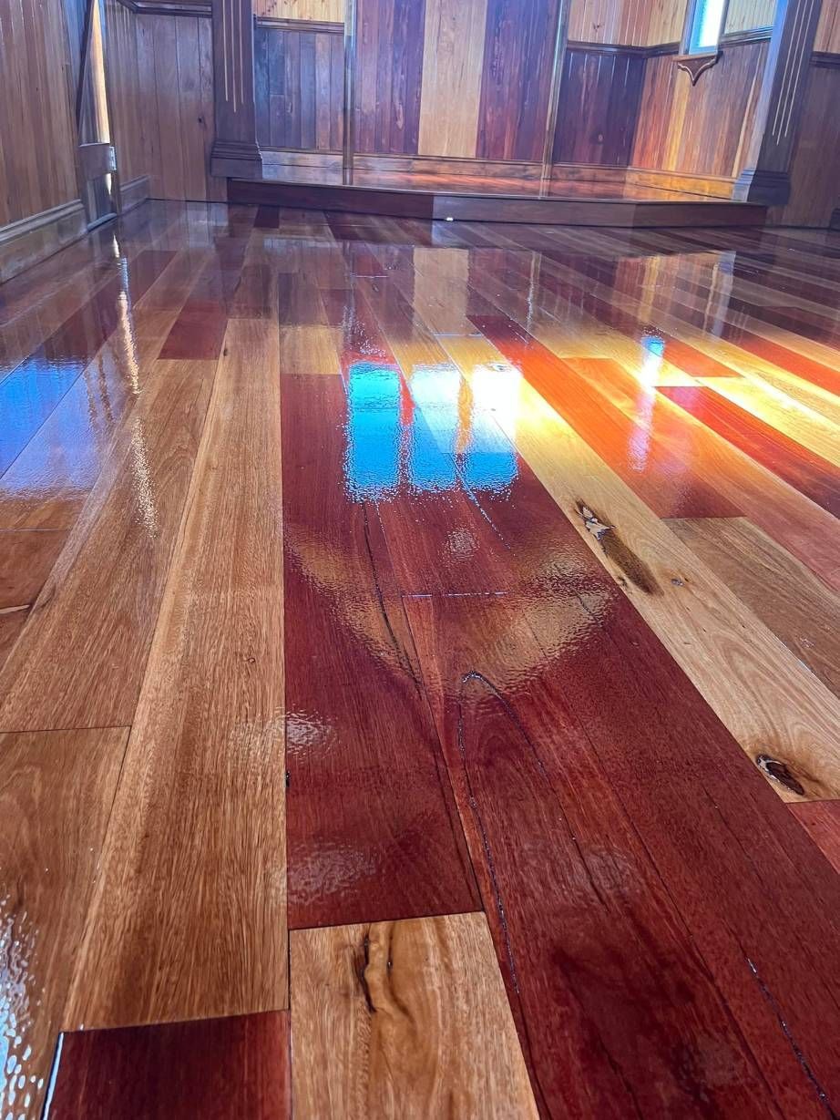 A Close Up of a Wooden Floor With a Reflection of a Window — Toowoomba Polished Floors in Highfields, QLD