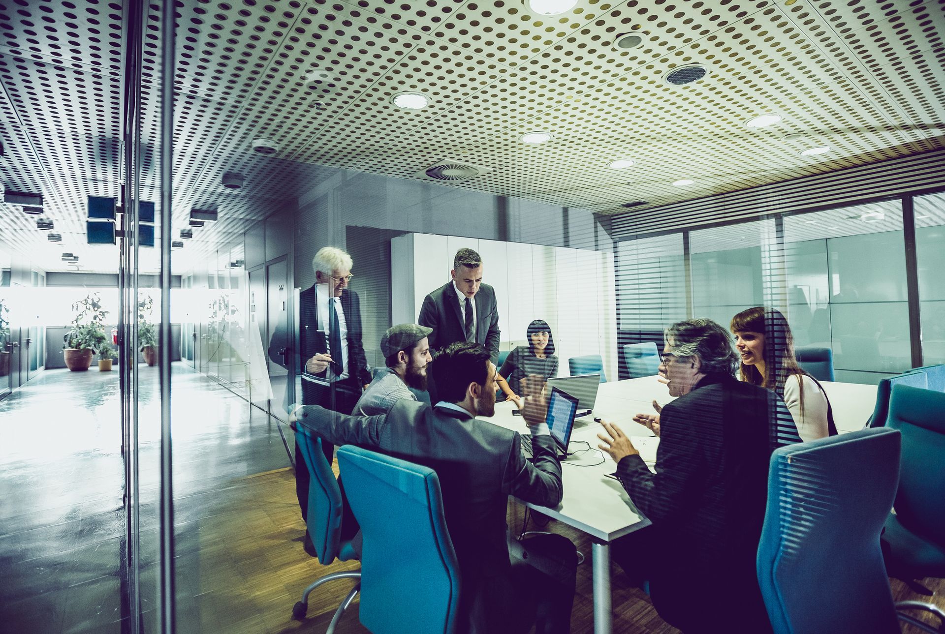 A group of business people are having a meeting in a conference room.