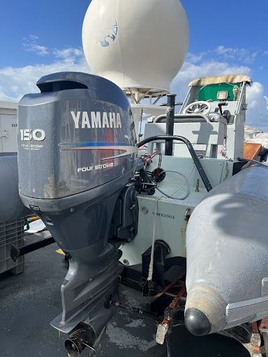 A yamaha outboard motor is sitting on top of a boat.