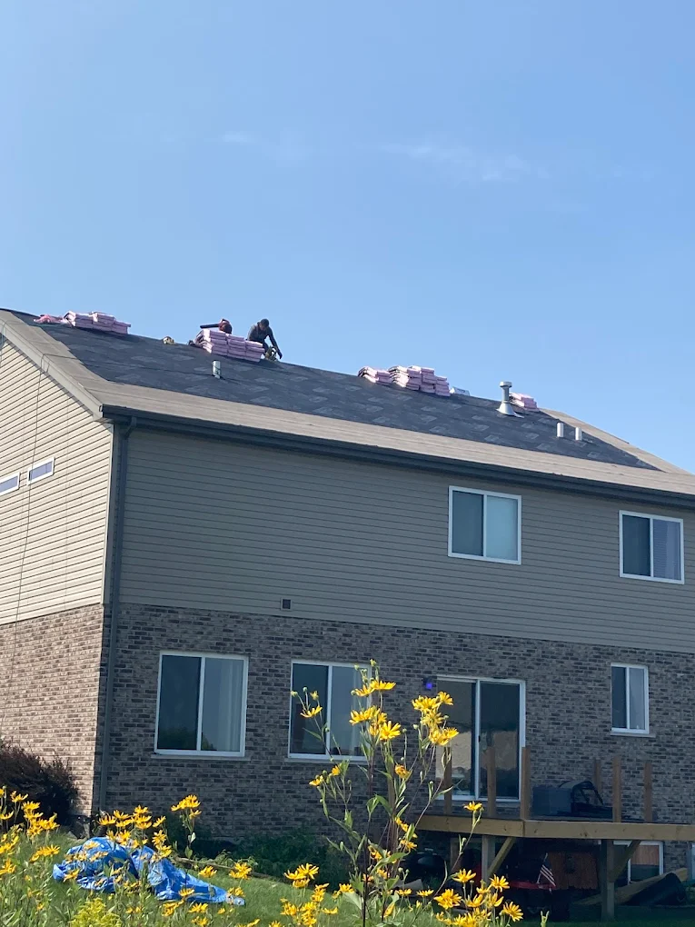 Roof contractor on a steep roof performing professional roofing services. Roof contractor on a steep roof performing professional roofing services.