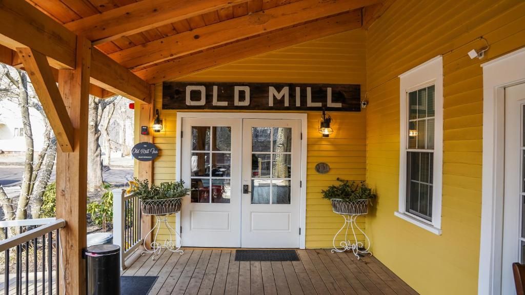 A yellow building with a sign that says old mill on it