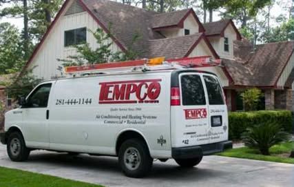 White TEMPO service van parked in front of a house, with a ladder on the roof.