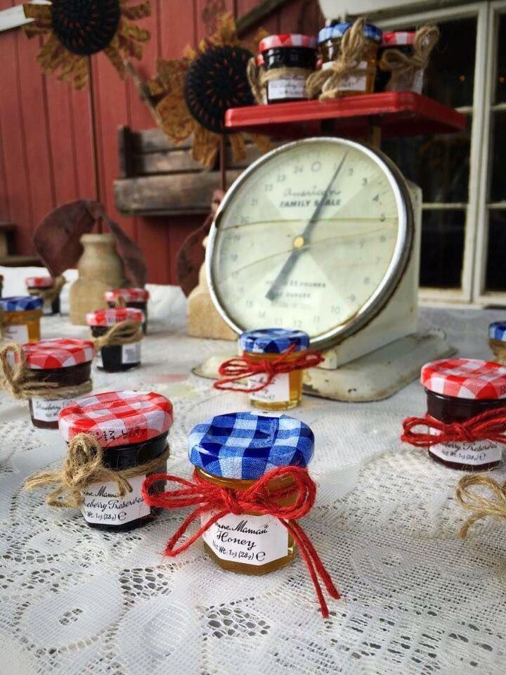Jars of jam are on a table with a clock in the background