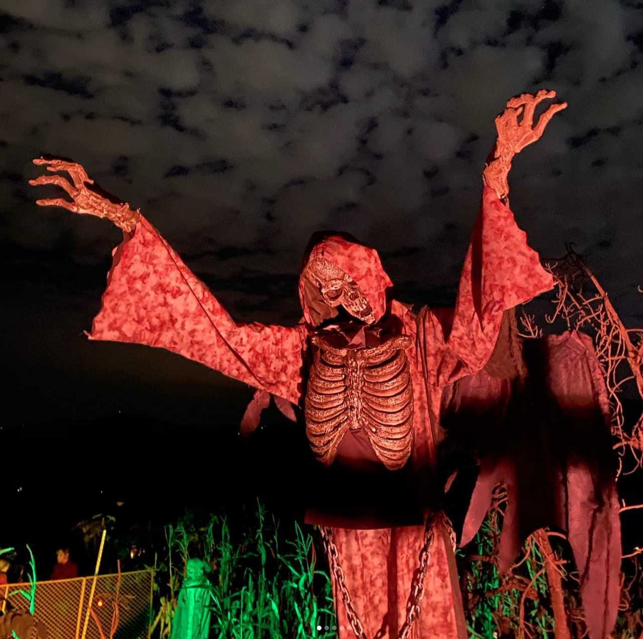 A statue of a skeleton in a red robe