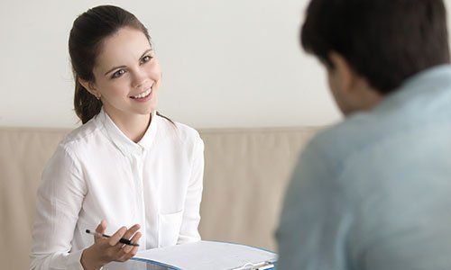 HR manager wearing white shirt holding resume