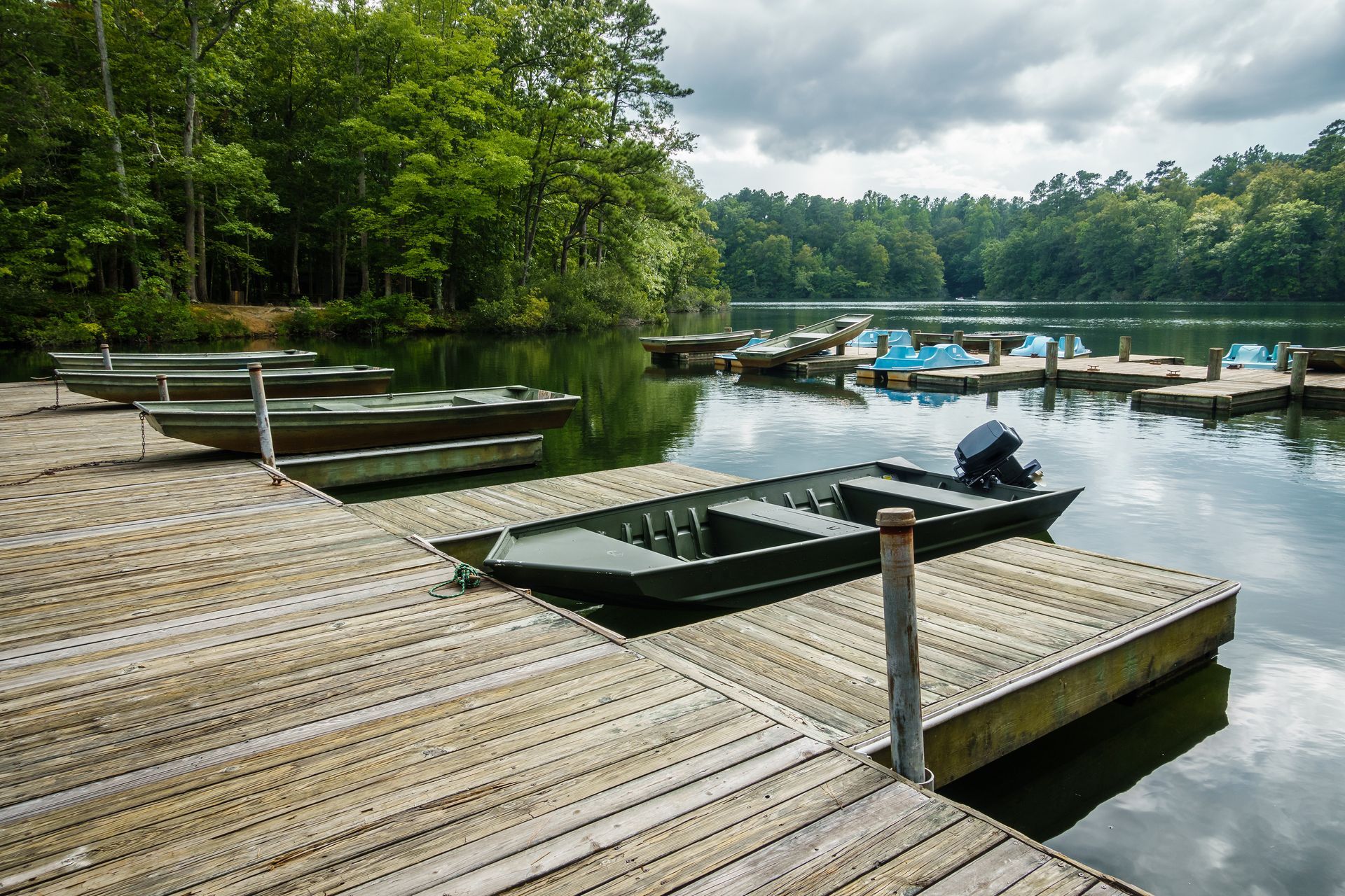 Row of mobile homes along a pathway, evening lighting, pale blue and white colors.
