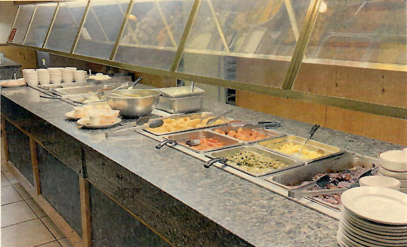 A buffet line with a variety of food on it