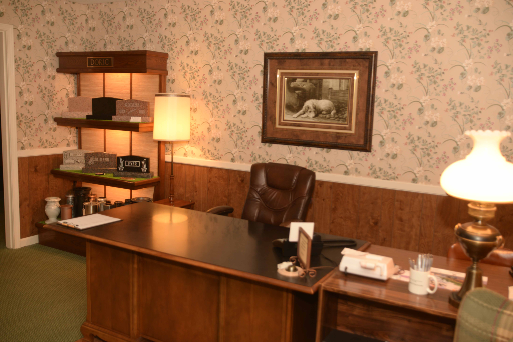 An office with a desk and chair and a lamp