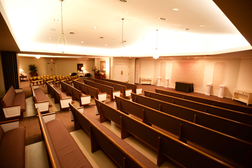 An empty church with rows of wooden benches