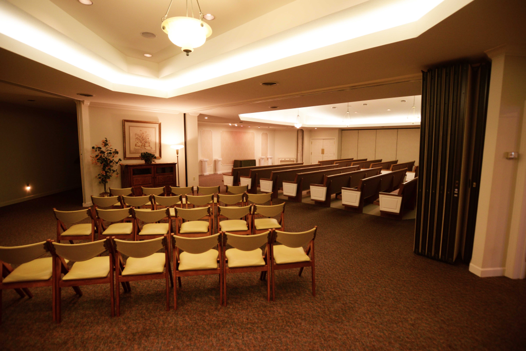 Rows of chairs are lined up in a large room