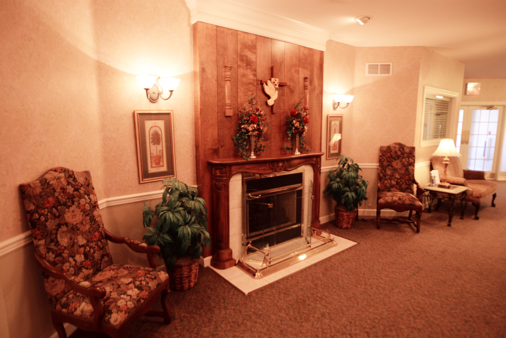 A living room with a fireplace and chairs in it