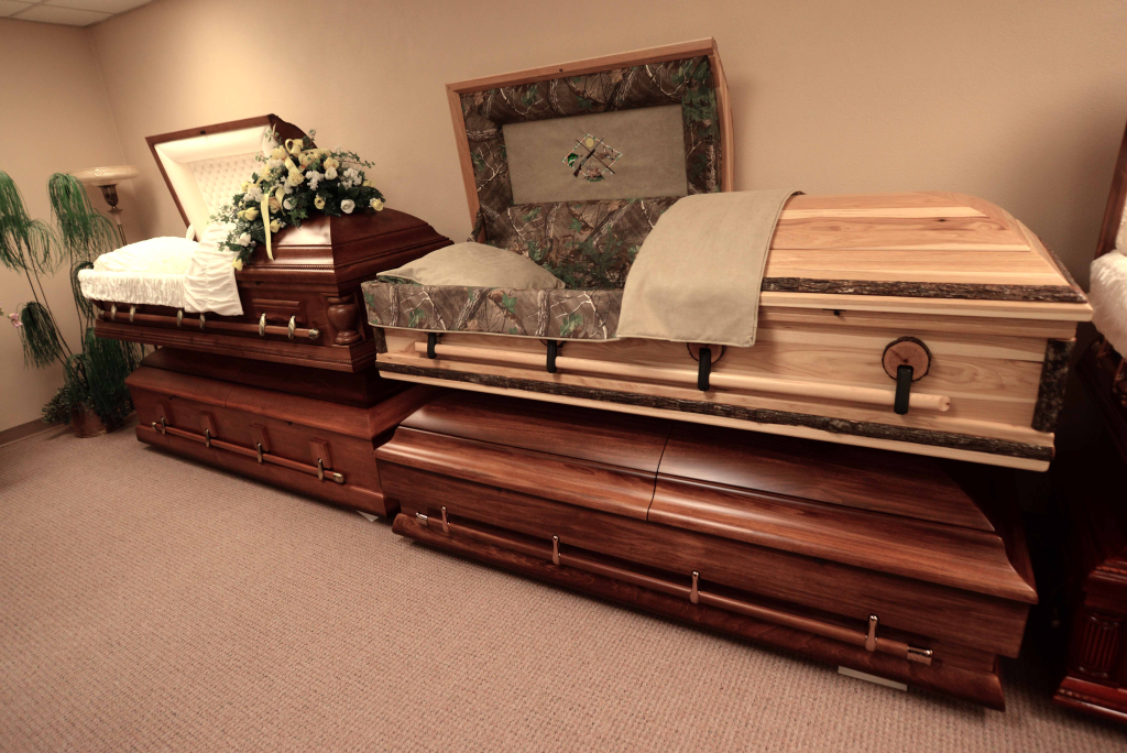 Three coffins are stacked on top of each other in a room.