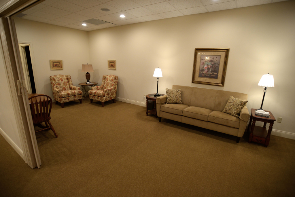 A living room with a couch and two chairs