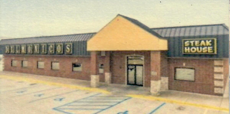 A picture of a steak house in a parking lot