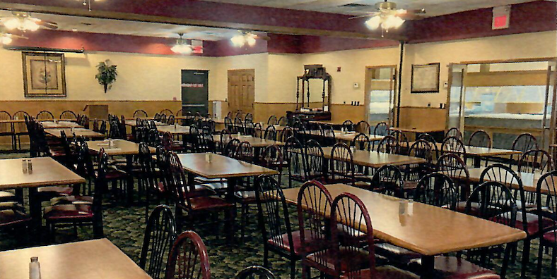 A large dining room with many tables and chairs