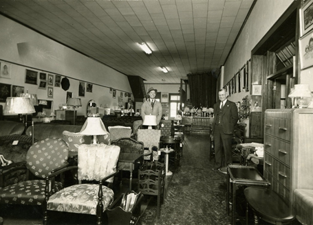 A black and white photo of a furniture store