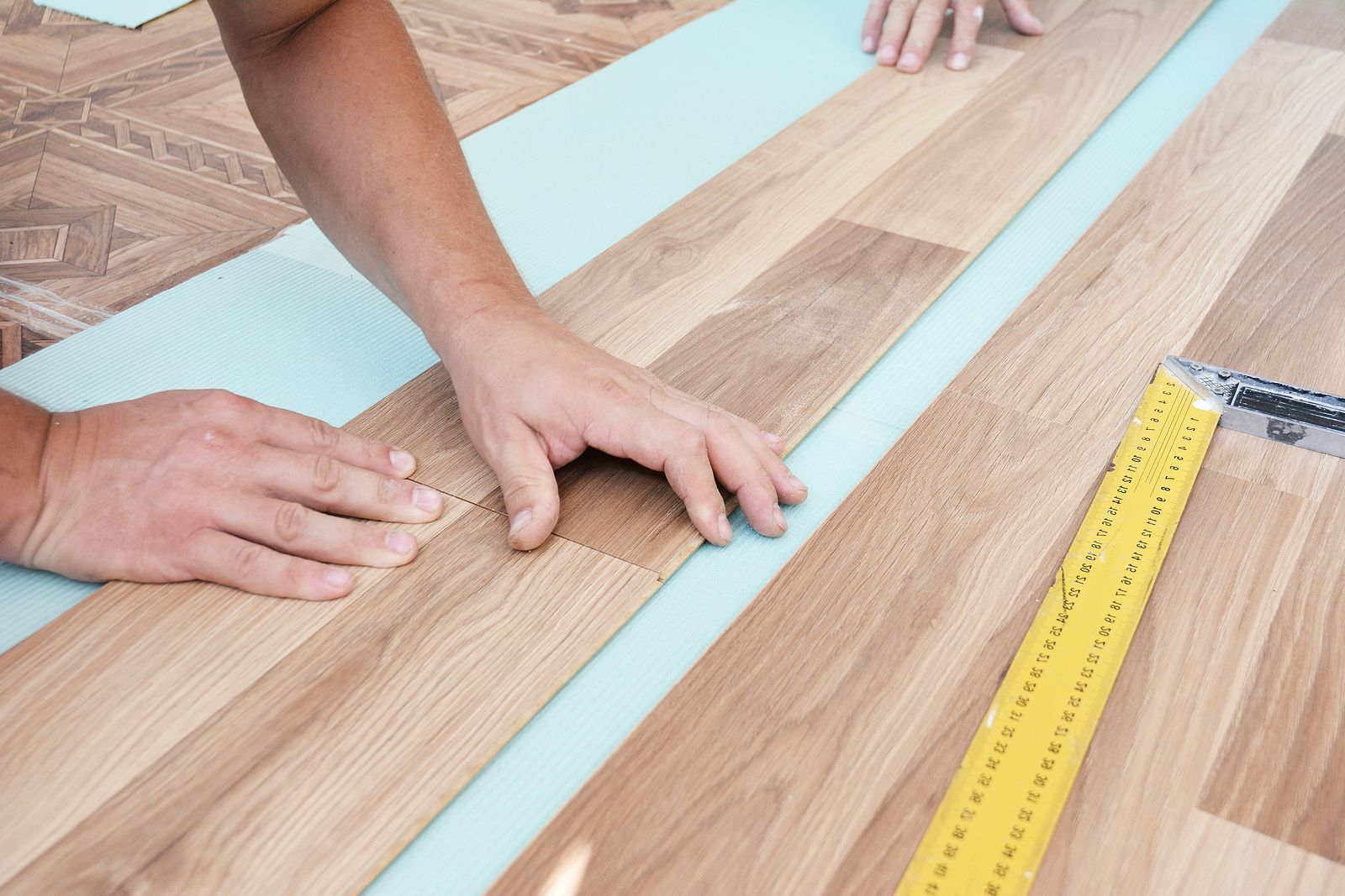 man installing hardwood floors