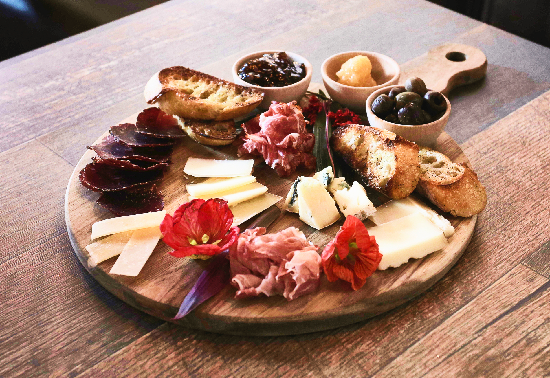 A white plate topped with a piece of salmon and vegetables.