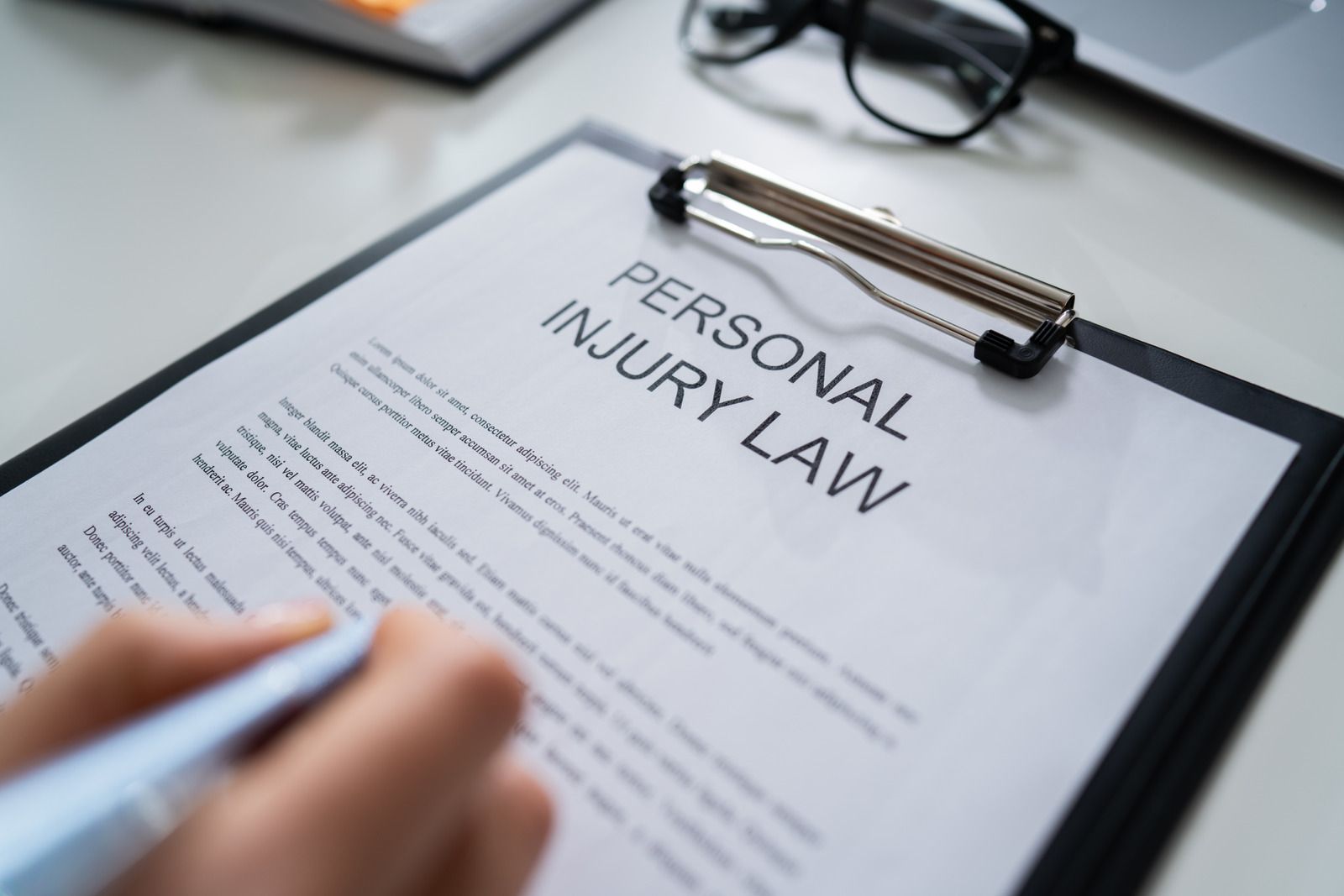 Person writing on a clipboard with 
