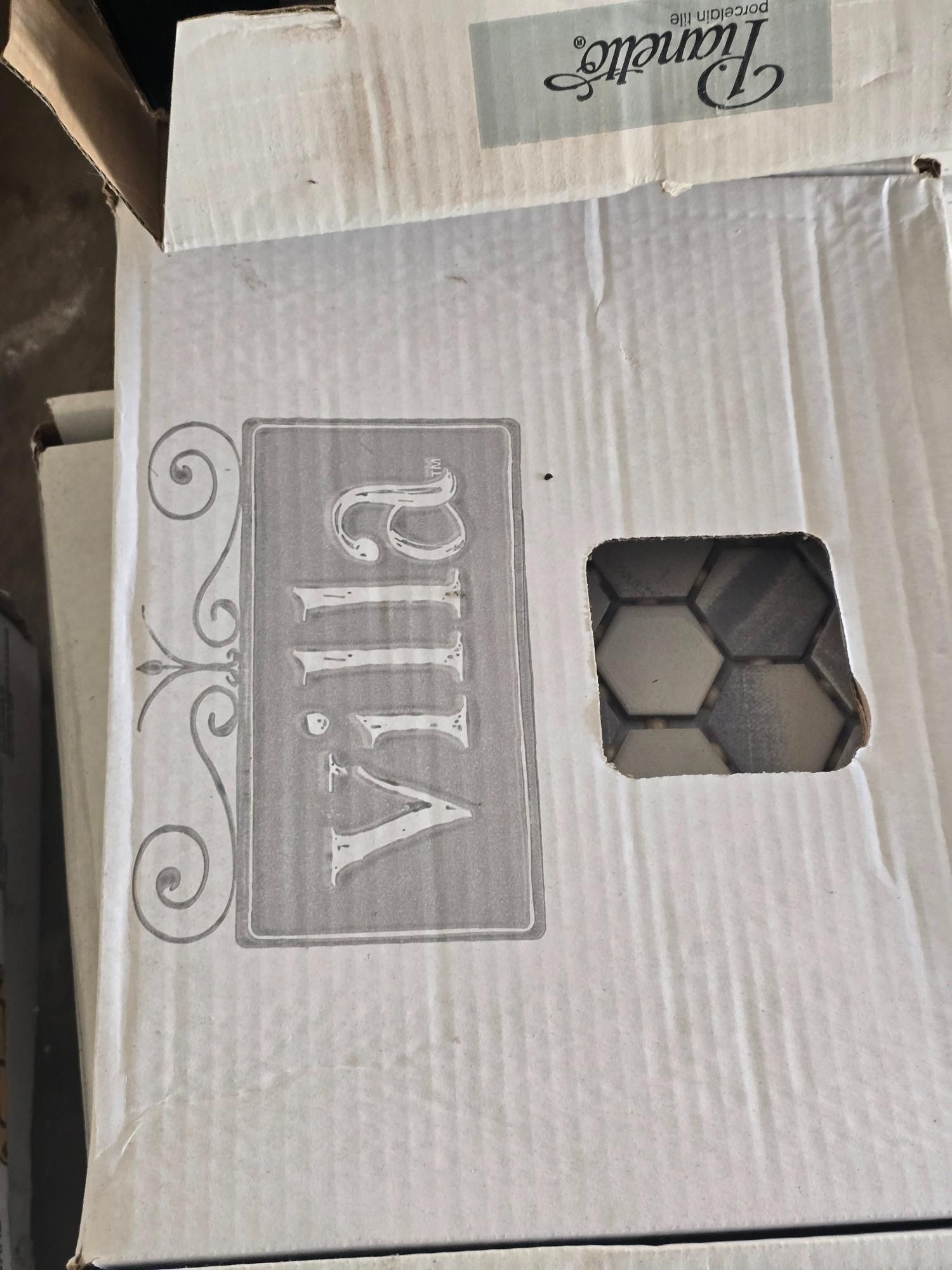 Cardboard tile box labeled 