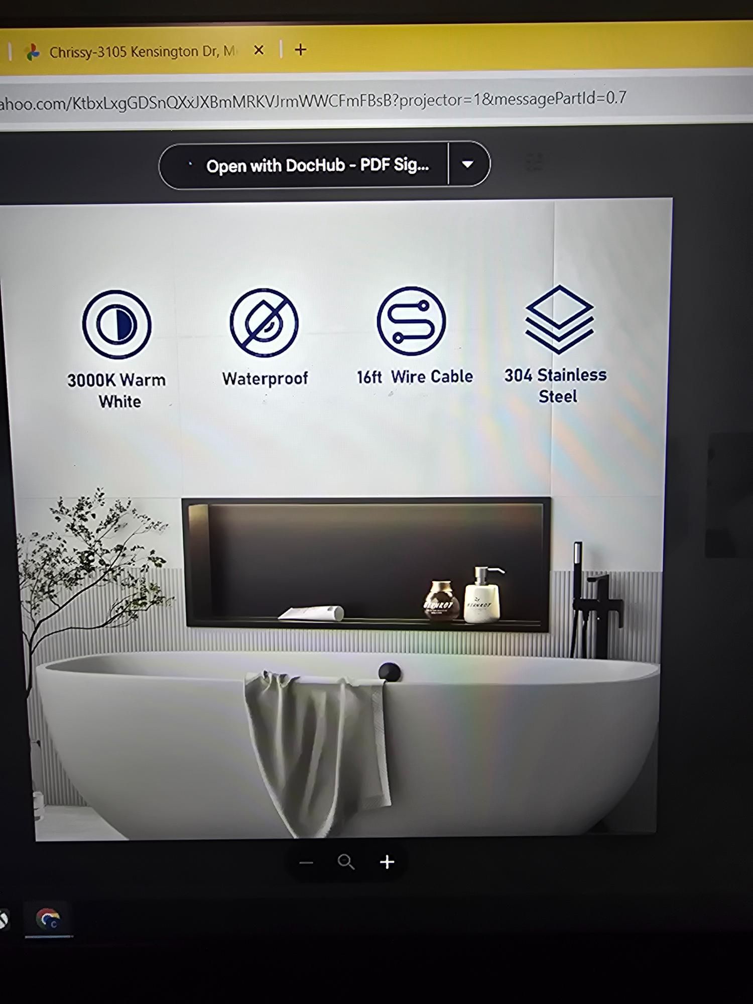 Bathtub in a modern bathroom with decorative icons at the top.