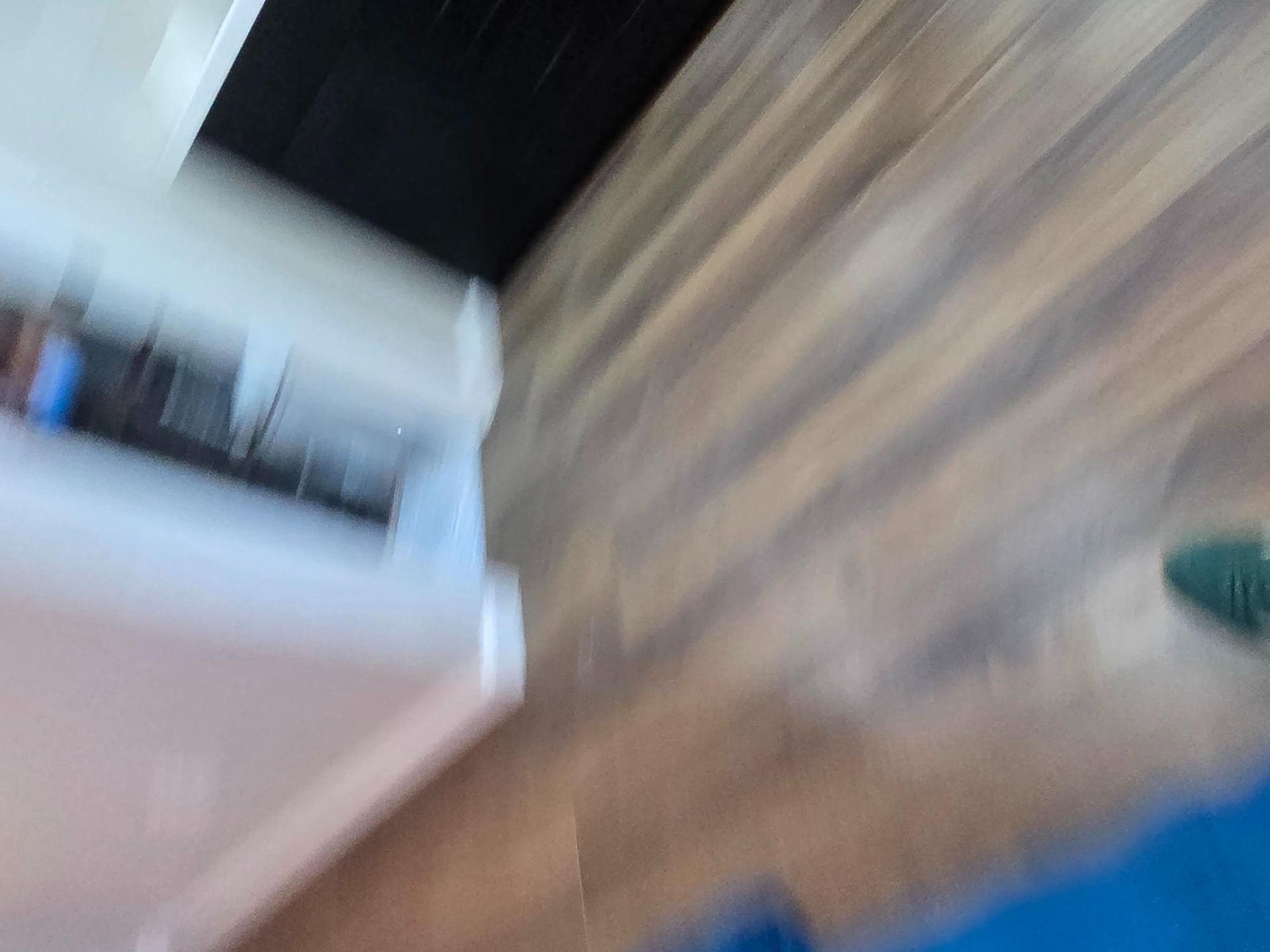 White cabinet and dark counter, wooden floor.