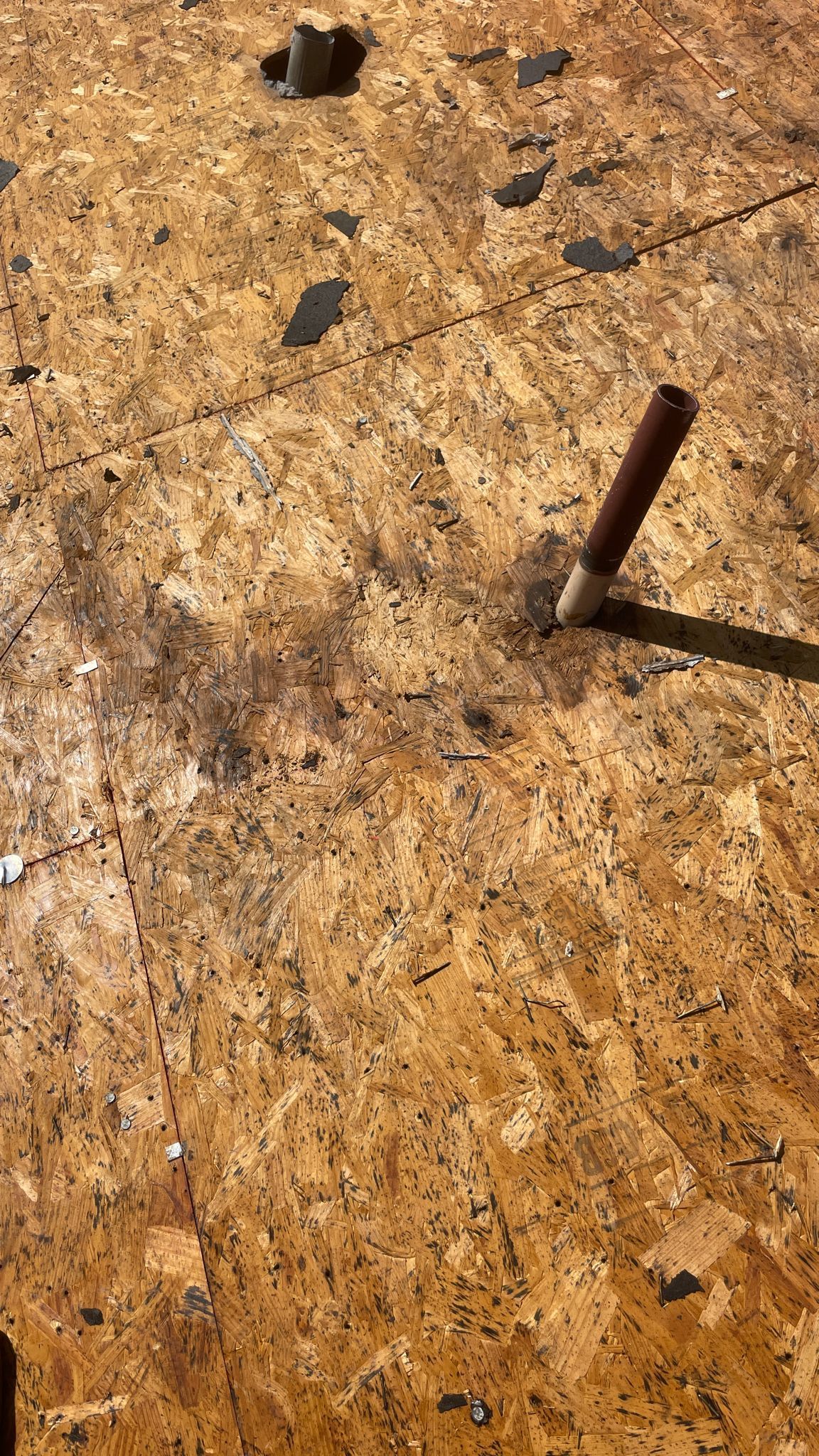 Brown wooden surface with a brown pipe.