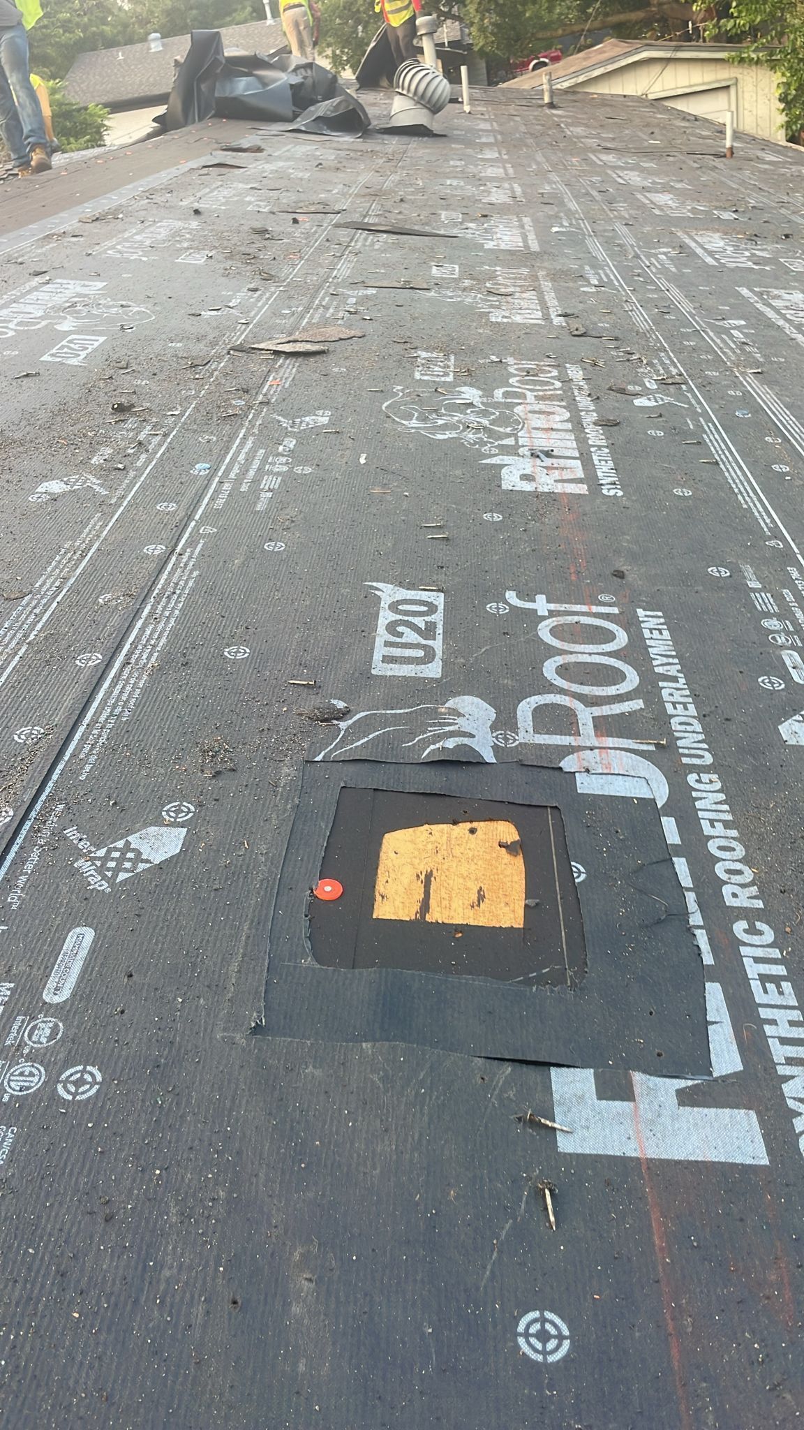 Dark roof with tear and repair patch; text 