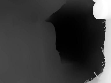 Dark torn surface with visible edges and light reflections.