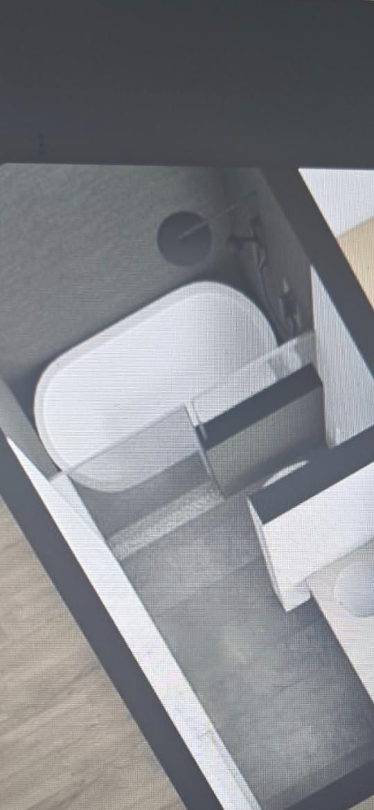 A minimalist bathroom design with a white oval bathtub.